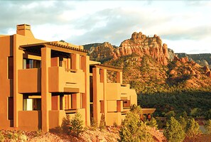 A modern building with a flat roof and large windows, surrounded by a mountainous landscape. - Hyatt Pinon Pointe (Sedona)