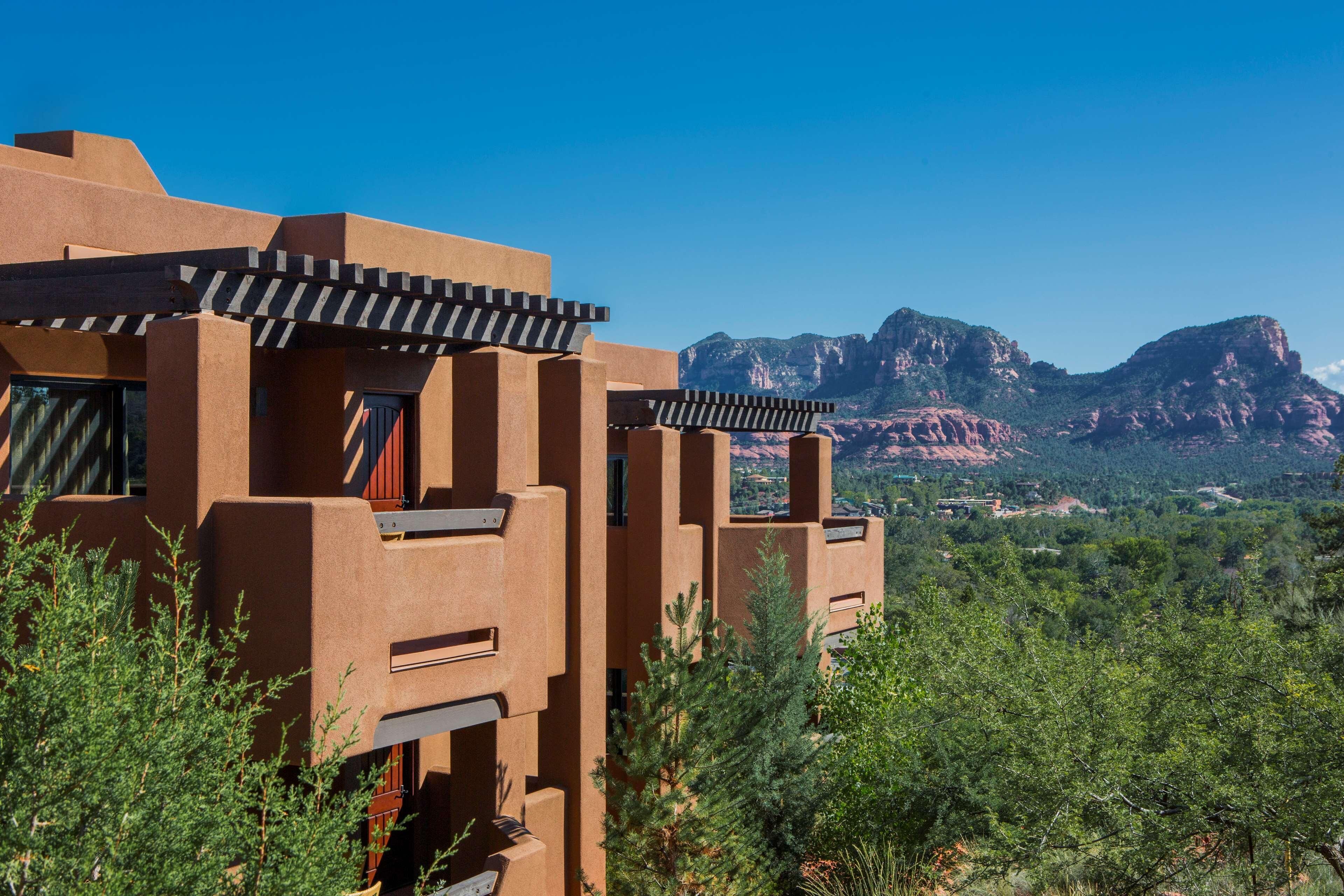 A building with a flat roof and a view of a mountainous landscape.