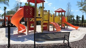 A playground with slides and a bench. - 6BR house sleeps 14 with private pool in davenport (Davenport)
