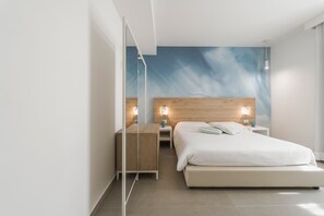 A modern bedroom with a large bed, bedside tables, a wooden headboard, and a wall mural. - Venti di Laguna Apartments Stagnone - Ponente (Marsala)