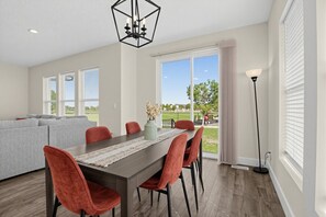 A dining area with a table, chairs, and a view of the outdoors. - Mountain View Home with Large Yard Near Salt Lake (Stansbury Park)