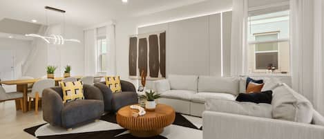 A modern living room with a sofa set, a coffee table, and a dining area with a table and chairs.