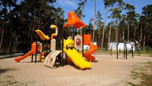 A playground with slides and climbing structures. - Apartment with swimming pool, Lukecin (Łukęcin)