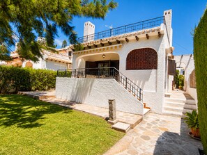 A building with a stone facade, a balcony, and a staircase leading to the entrance. - House With Garden & Beach (Orihuela)