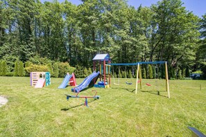 A playground with a slide, swings, and climbing structures.