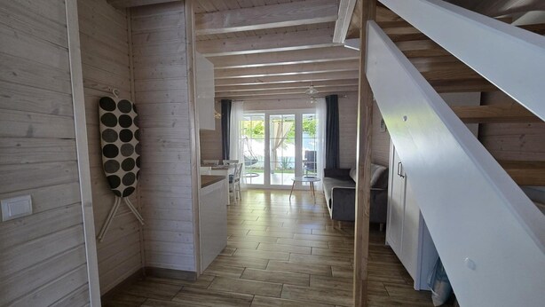 A wooden interior with a staircase, a dining area, and a view of the outdoors. - Large holiday homes with beautiful gardens (Pobierowo)