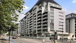A multi-story building with a modern architectural design, featuring balconies and large windows. - Luxury Flat in Chelsea Bridge (Greater London)
