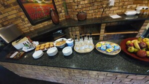 A buffet counter with various food items and condiments.
