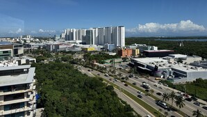 A cityscape with modern high-rise buildings, a busy road, and a clear blue sky. - San Francisco Cancun (Cancun)