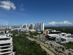 A cityscape with modern high-rise buildings, a busy road, and a clear blue sky. - San Francisco Cancun (Cancun)