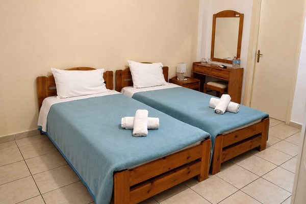 Bright and welcoming bedroom featuring comfortable bedding and natural light. A relaxing space designed for a restful stay, with cozy furnishings, and everything needed for a comfortable getaway