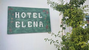 A green sign with 'HOTEL ELENA' written on it, mounted on a white wall. - Hotel Elena -Sunny Seaside Balcony Suite in Skyros (Skyros)