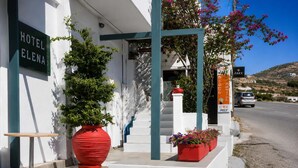 A hotel entrance with a sign reading 'HOTEL ELENA,' a red planter, and a staircase leading to the entrance. - Hotel Elena -Sunny Seaside Balcony Suite in Skyros (Skyros)