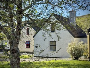 A white house with a red window, a chimney, and a number '73' on the wall. - Cottage 504 - Clifden - sleeps 5 guests  in 3 bedrooms (Clifden)
