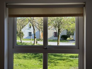 A window with a view of a house and trees. - Cottage 504 - Clifden - sleeps 5 guests  in 3 bedrooms (Clifden)