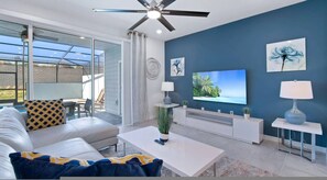 A modern living room with a sofa, coffee table, TV, and artwork on the wall. - Go!#36 - WINDSOR ISLAND (Davenport)