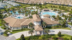 A residential area with multiple houses, a swimming pool, and a small tower-like structure. - Go!#34 - CHAMPIONS GATE (Davenport)