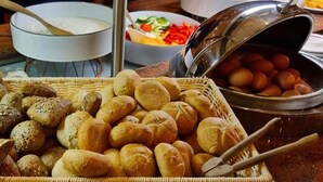 A buffet table with various breads, a pot of soup, and a basket of eggs. - 1 Person Holiday Park Home in Dortmund (Dortmund)
