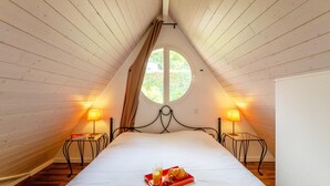 A bedroom with a bed, two bedside tables, a window, and a tray with breakfast items. - French Riviera Bay Retreat (Arcachon)