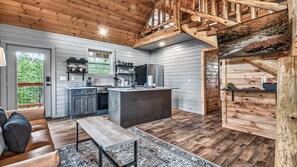 A modern kitchen with wooden accents, a dining area with a bench, and a staircase.