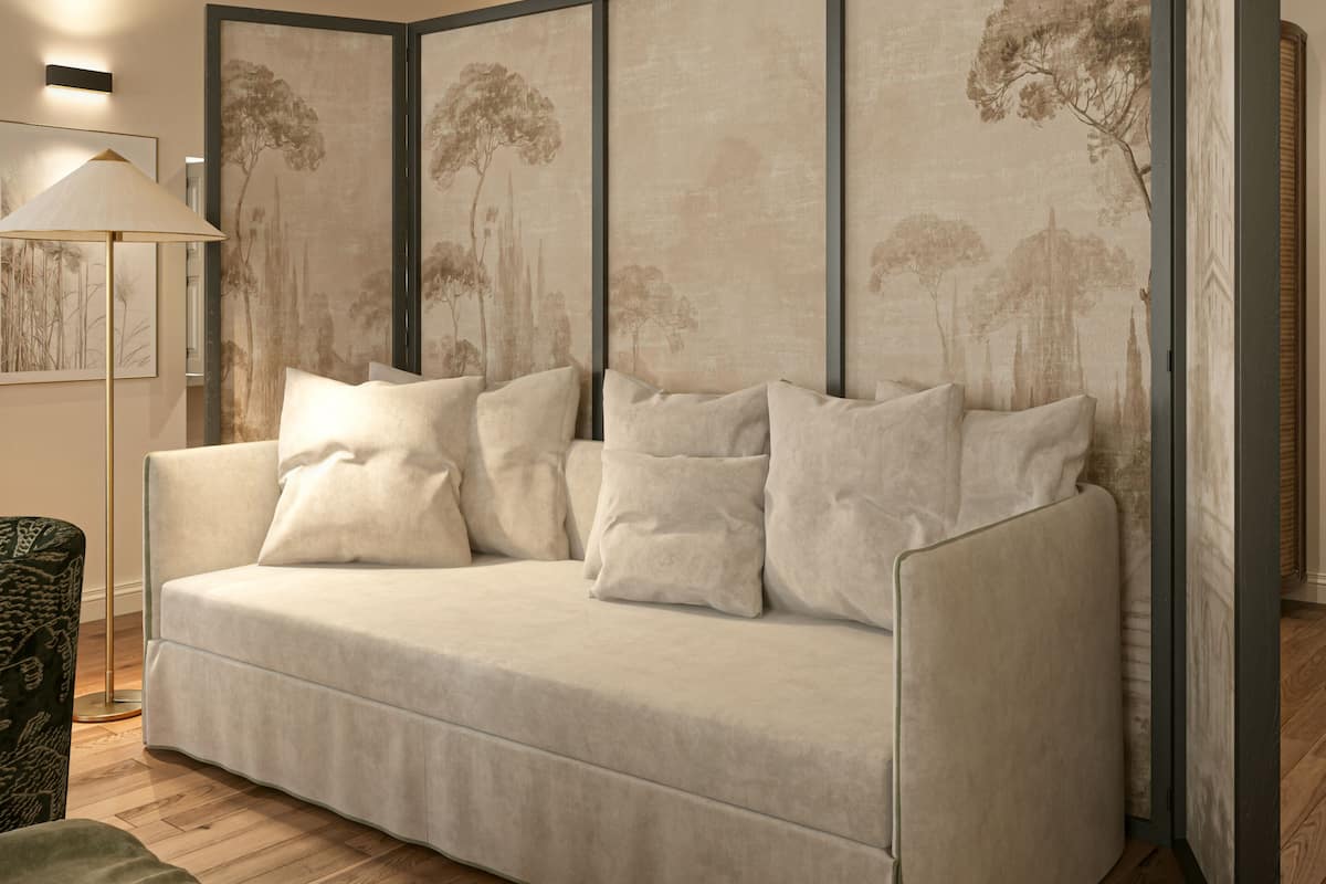 A modern living room with a sofa, a floor lamp, and a large artwork on the wall.