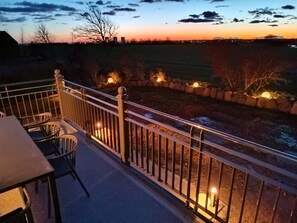 A balcony with a railing, a table, and chairs. - Ruhe, Natur & Strandnahe auf Fehmarn (Fehmarn)