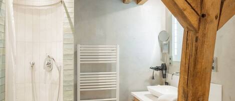 A bathroom with a shower, toilet, and sink.