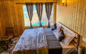 A wooden room with a bed, curtains, a bench, and a window with a view. - Four Wooden Rooms ROUTE707 Resorts Orchard Kanatal (Kanatal)