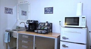 Fridge, microwave, coffee/tea maker, cookware/dishes/utensils
