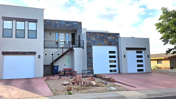 A modern two-story house with a garage, a covered patio, and a stone facade. - Private, Modern Casita, Coffee Bar, Wet Bar (Page)