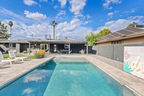 A residential property with a swimming pool, outdoor seating, and solar panels. - The Hideaway at Chandler (Chandler)