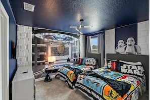 Ein Schlafzimmer im Stil von Star Wars mit einem Bett, Star Wars-Postern und einem außergewöhnlichen Deckenstil.