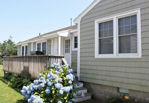 A row of single-story mobile homes with a wooden deck and a garden with hydrangea bushes. - 66n Gorton Avenue, Old Lyme, CT (Old Lyme)