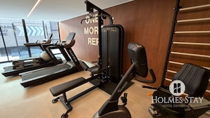 A gym with treadmills, a bench press, and a wall with motivational text. - First floor apartment with terrace at Acqua Tambau AQTX3 (João Pessoa)