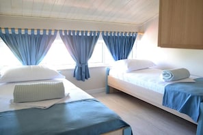 A room with two beds, a wooden ceiling, and curtains. - Open Doors Bed & Breakfast  (Shkodër)