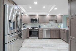A modern kitchen with stainless steel appliances, a microwave, and a dishwasher. - Santa Maria 1 #3205- Manatee Cove (Fort Myers Beach)