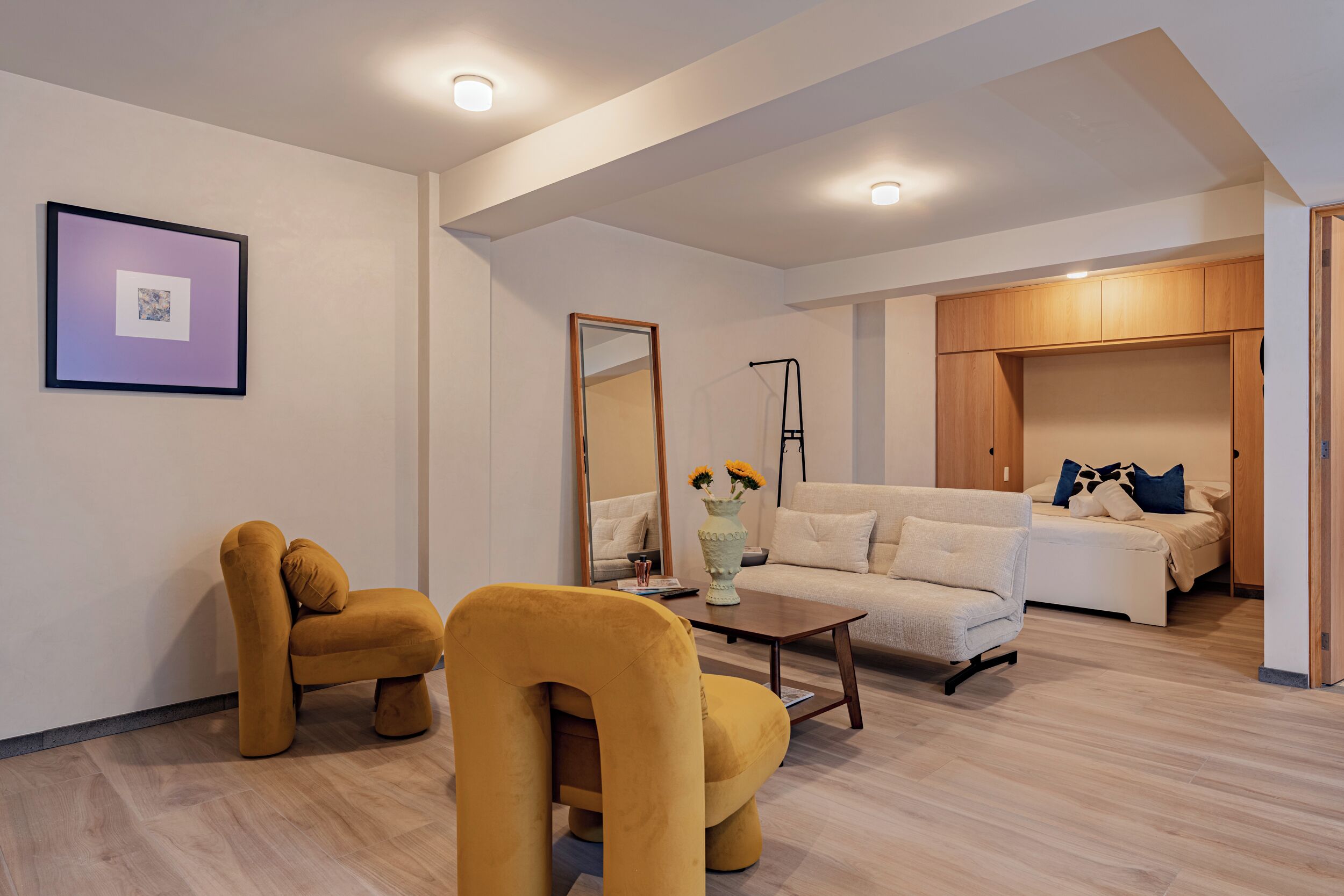 A modern living room with a sofa, armchair, and coffee table.