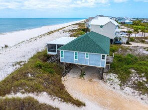 A beachfront house with a green roof, a balcony, and a view of the ocean. - Turtle's Nest (Port St. Joe)