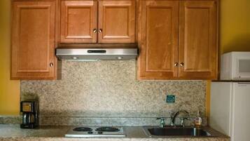 Fridge, microwave, coffee/tea maker, cookware/dishes/utensils