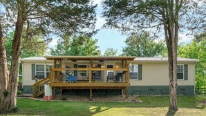 A two-story house with a deck, a staircase, and a front porch. - Atchley Hill Farm (Knoxville)