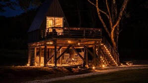 A wooden cabin with a balcony, a staircase, and a deck area. - Eagle’s Nest Couples Escape w/ Hot Tub & Firepit (Cherokee)