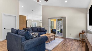 A modern living room with a sofa set, a coffee table, and a wooden floor. - Seal Point Escape - NEW! (Lamoine)