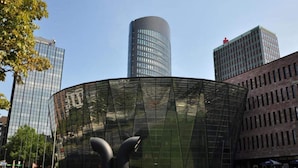 A modern building with a curved glass facade and a cylindrical structure in the background. - 2 Person Holiday Park Home in Dortmund (Dortmund)