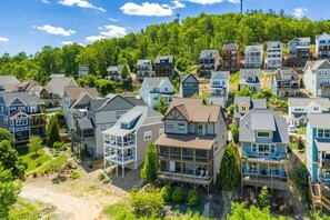 A residential area with houses featuring various architectural styles, including modern and traditional designs, with visible balconies and attached garages. - Three Sisters Summit: Mountain Views, Game Room (Black Mountain)