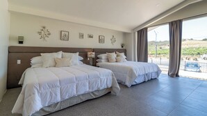 A hotel room with two beds, a large window with a view, and a balcony. - Casa Bugambilias by Villa de La Rosa (Valle de Guadalupe)