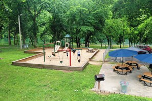 A park with playground equipment, picnic tables, and a covered area. - 3 Bedroom, 3 Bath Spacious End Unit Condo on Lake Taneycomo in Pointe Royale (Branson)