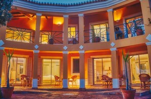 A multi-level hotel with balconies, large windows, and outdoor seating areas. - Seaview Studio Apartment Sleeps 3 With Pool (Lagos)