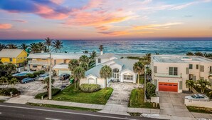 A two-story house with a garage, a driveway, and a lawn. - 861 S Atlantic Ave (Cocoa Beach)