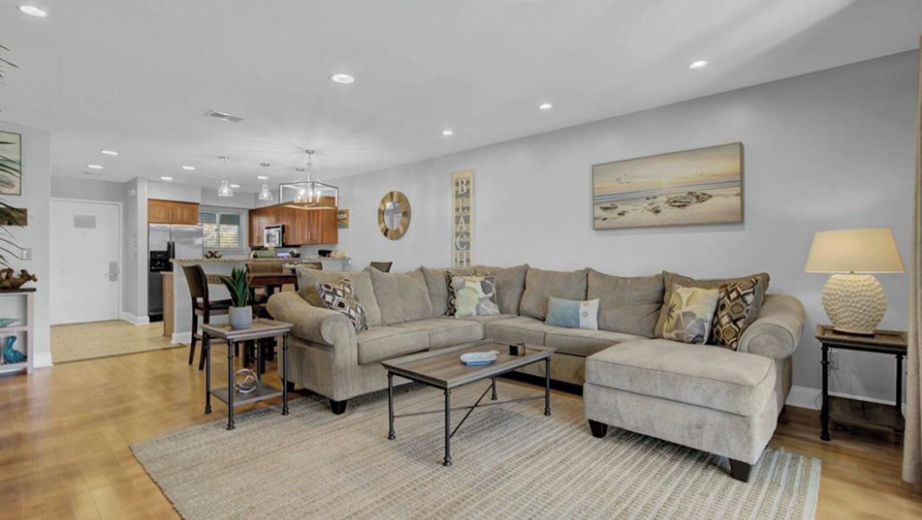 A living room with a sectional sofa, a coffee table, and a rug.