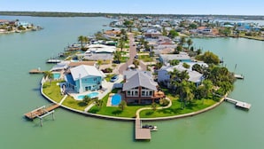 A waterfront property with a large house, a swimming pool, and a dock. - Waterfront Home with Pool in Redington Beach (Redington Beach)